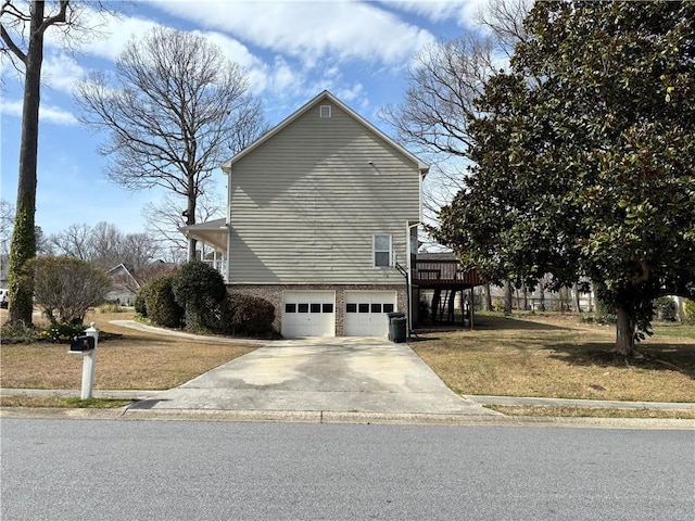 view of home's exterior featuring central AC unit, a lawn, an attached garage, and driveway