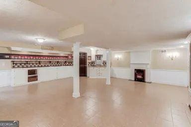 finished basement with a fireplace with flush hearth