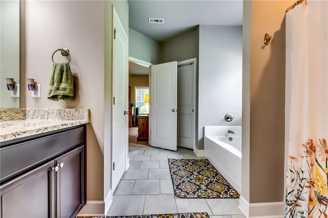 1412 Chapman Cir, Monroe, GA 30656 - bathroom with vanity, tile patterned flooring, and a bath