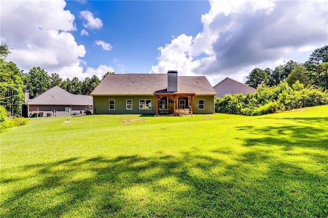 1412 Chapman Cir, Monroe, GA 30656 - rear view of house featuring a lawn and a chimney