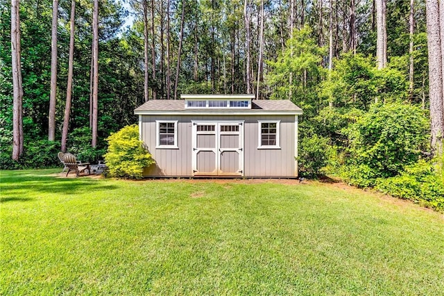 1412 Chapman Cir, Monroe, GA 30656 - view of shed with an outdoor fire pit and a forest view