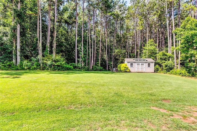 1412 Chapman Cir, Monroe, GA 30656 - view of grassy yard with a storage shed and a view of trees