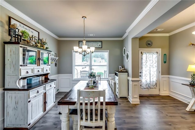 1412 Chapman Cir, Monroe, GA 30656 - dining area with a chandelier, healthy amount of natural light, wainscoting, dark wood-style floors, and a decorative wall