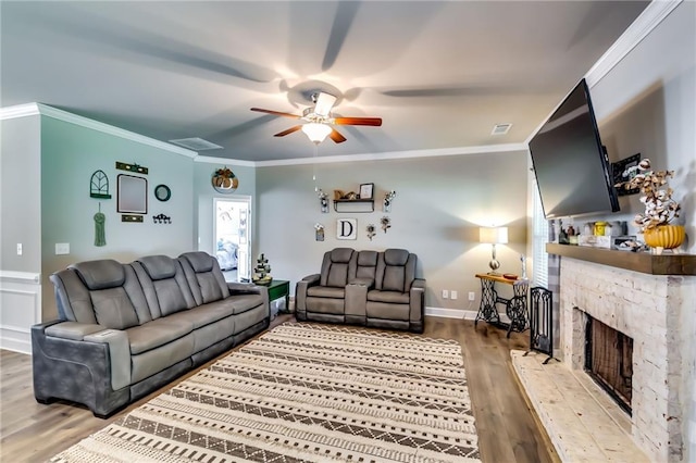 1412 Chapman Cir, Monroe, GA 30656 - living room with ceiling fan, wood finished floors, crown molding, and a stone fireplace