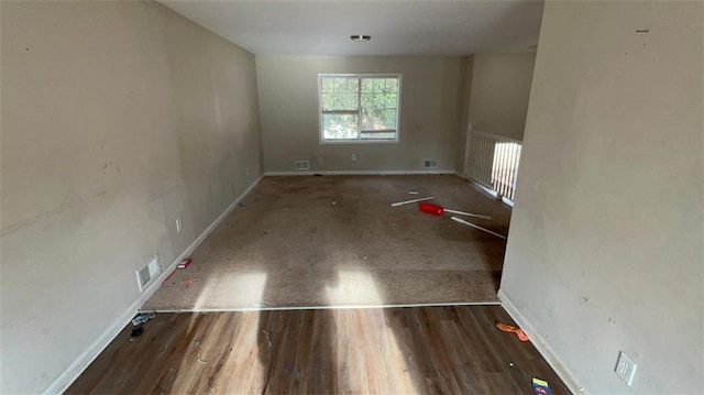 spare room with wood-type flooring