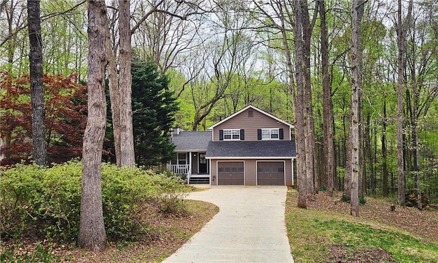 5415 Keithwood Dr, Cumming, GA 30040 - split level home with a chimney, an attached garage, a view of trees, and concrete driveway