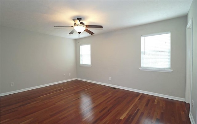 5415 Keithwood Dr, Cumming, GA 30040 - empty room with dark wood finished floors, baseboards, and a ceiling fan