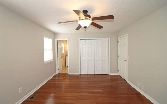 5415 Keithwood Dr, Cumming, GA 30040 - unfurnished bedroom featuring wood finished floors, baseboards, a closet, and visible vents
