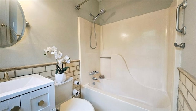 5415 Keithwood Dr, Cumming, GA 30040 - full bath with toilet, tile walls, shower / bath combination, vanity, and a wainscoted wall