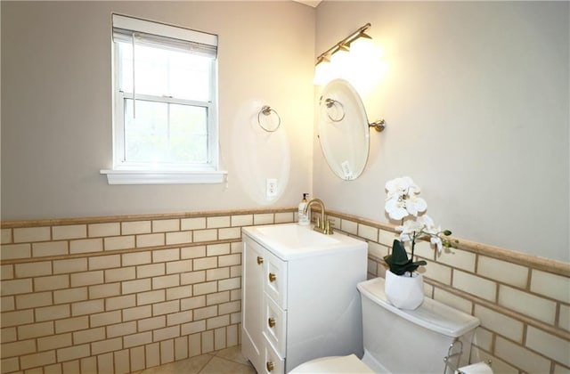 5415 Keithwood Dr, Cumming, GA 30040 - half bath with vanity, tile patterned floors, toilet, wainscoting, and tile walls