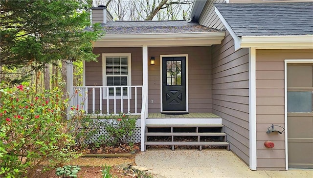 5415 Keithwood Dr, Cumming, GA 30040 - view of exterior entry featuring a porch, roof with shingles, and a chimney