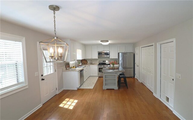 5415 Keithwood Dr, Cumming, GA 30040 - kitchen featuring a sink, appliances with stainless steel finishes, a chandelier, and light wood finished floors