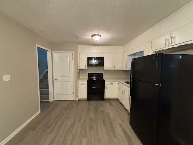 kitchen featuring white cabinetry, black appliances, and wood-type flooring