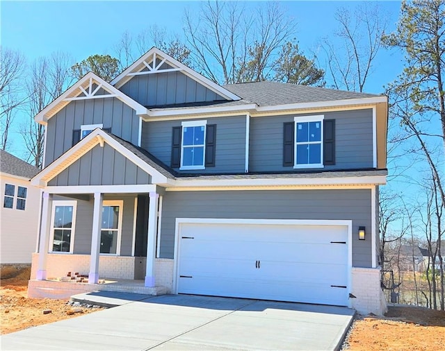 craftsman-style house with a garage, a shingled roof, concrete driveway, board and batten siding, and brick siding