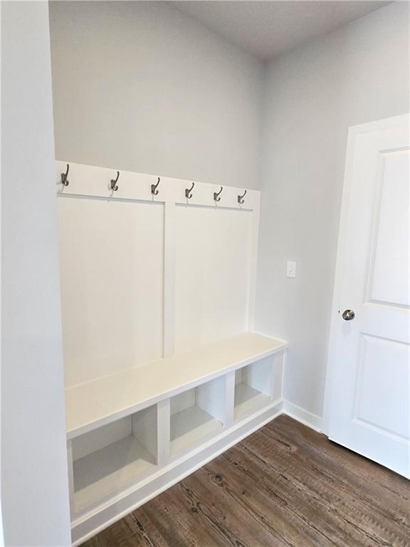 mudroom with dark wood finished floors