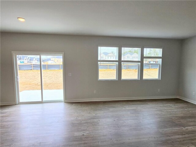 mudroom with baseboards and wood finished floors