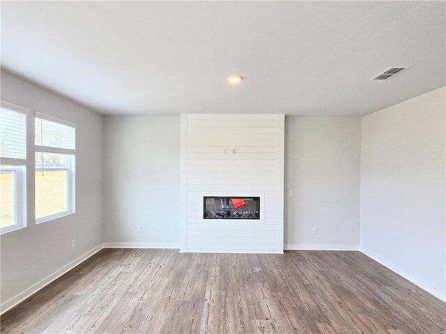 empty room featuring dark wood-type flooring and baseboards