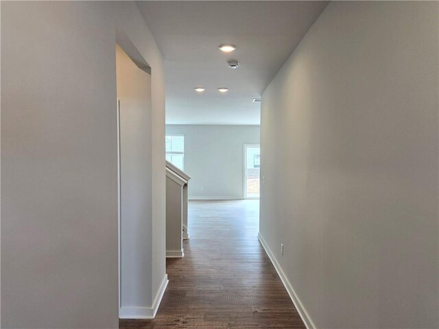 interior space featuring dark colored carpet and baseboards