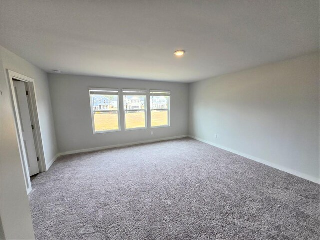 bathroom with a spacious closet, a shower stall, vanity, wood finished floors, and baseboards