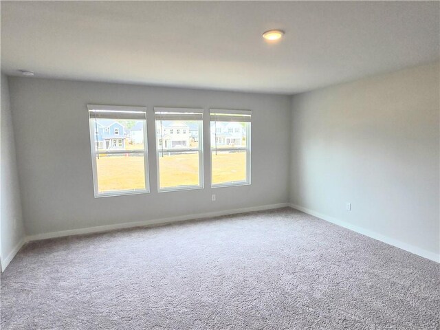 empty room with carpet floors and baseboards