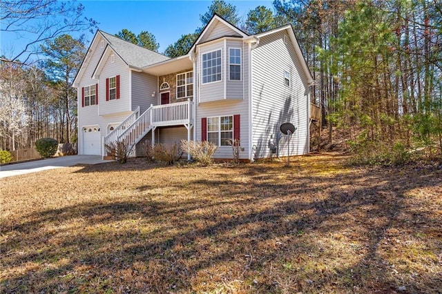 view of front of home with driveway, stairway, and an attached garage