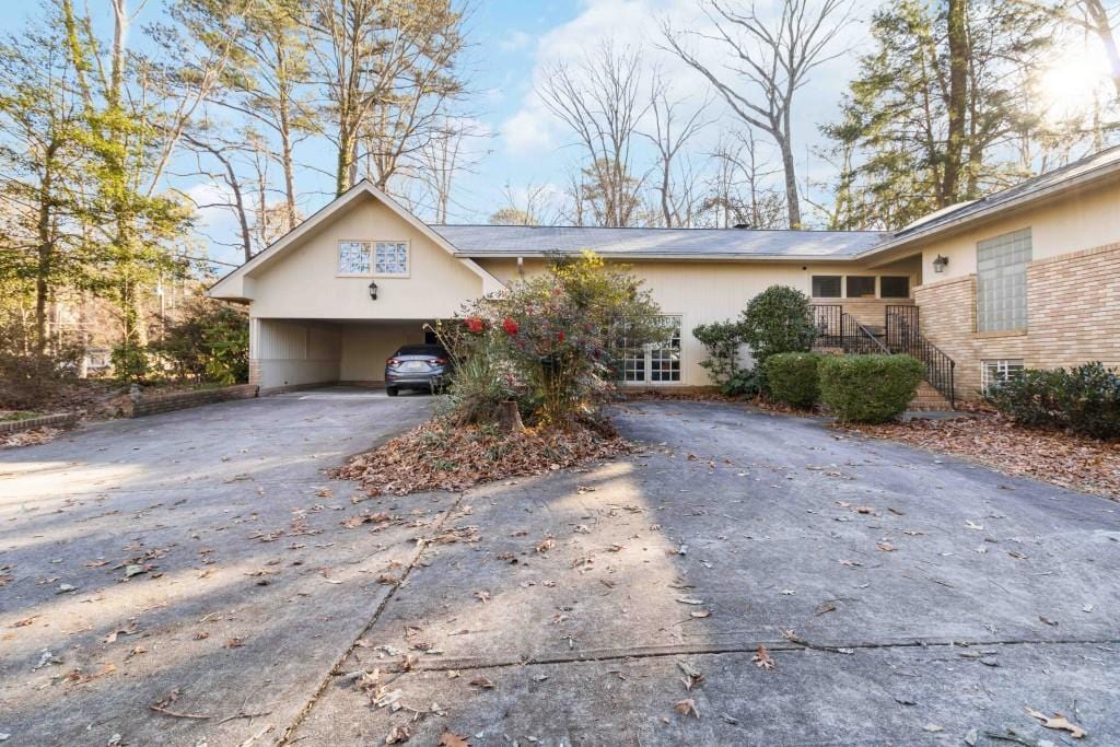 single story home featuring a carport