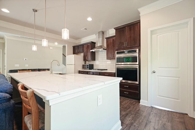 1630 Eaglerock Dr, Suwanee, GA 30024 - kitchen featuring stainless steel double oven, wall chimney range hood, freestanding refrigerator, dark brown cabinets, and tasteful backsplash