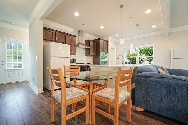 1630 Eaglerock Dr, Suwanee, GA 30024 - dining area with ornamental molding, recessed lighting, and dark wood-style flooring