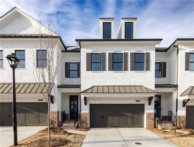 707 Dodd Ln N Unit 164, Buford, GA 30518 - multi unit property featuring brick siding, a garage, driveway, and a standing seam roof