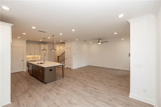 707 Dodd Ln N Unit 164, Buford, GA 30518 - kitchen with a sink, dishwasher, ceiling fan, light countertops, and an island with sink