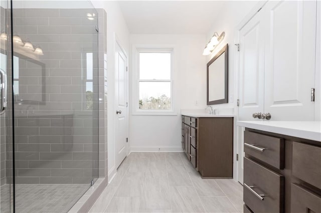 707 Dodd Ln N Unit 164, Buford, GA 30518 - bathroom with a stall shower, vanity, baseboards, and marble look tiles