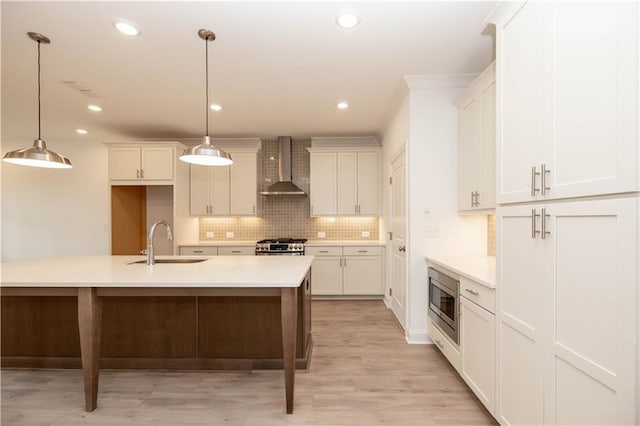 707 Dodd Ln N Unit 164, Buford, GA 30518 - kitchen with wall chimney range hood, appliances with stainless steel finishes, tasteful backsplash, a sink, and light countertops
