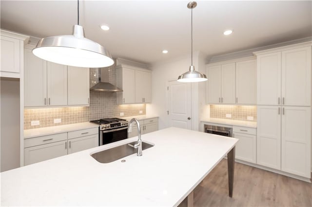 707 Dodd Ln N Unit 164, Buford, GA 30518 - kitchen with wall chimney range hood, gas range, a sink, tasteful backsplash, and light countertops