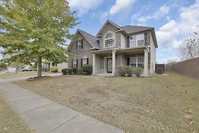 view of front facade featuring a front yard and cooling unit