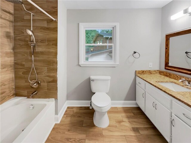 full bathroom featuring tiled shower / bath combo, vanity, toilet, and hardwood / wood-style flooring