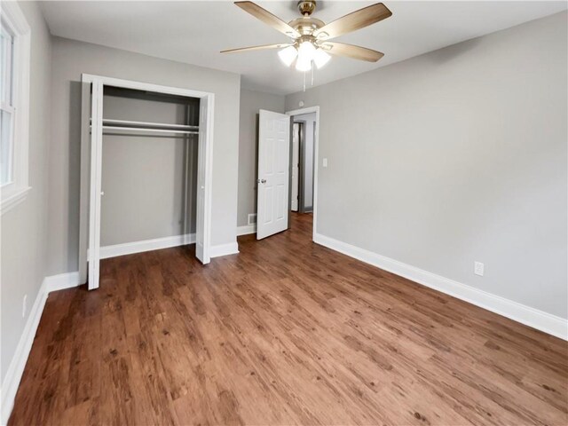 unfurnished bedroom with a closet, ceiling fan, and hardwood / wood-style flooring