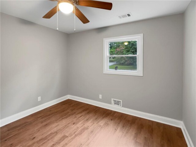 empty room featuring wood-type flooring and ceiling fan