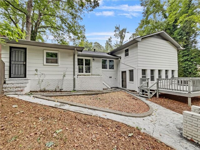 back of property with a wooden deck