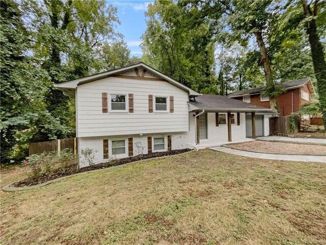 tri-level home with a front yard