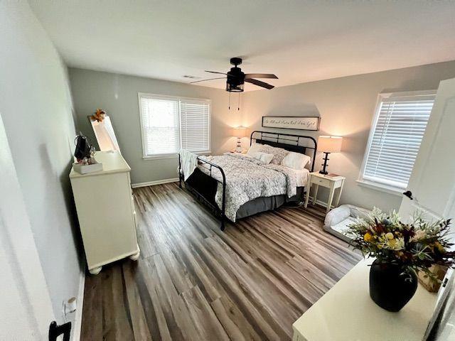 6060 Carriage Dr, Cumming, GA 30028 - bedroom with dark wood-style flooring, a ceiling fan, and baseboards