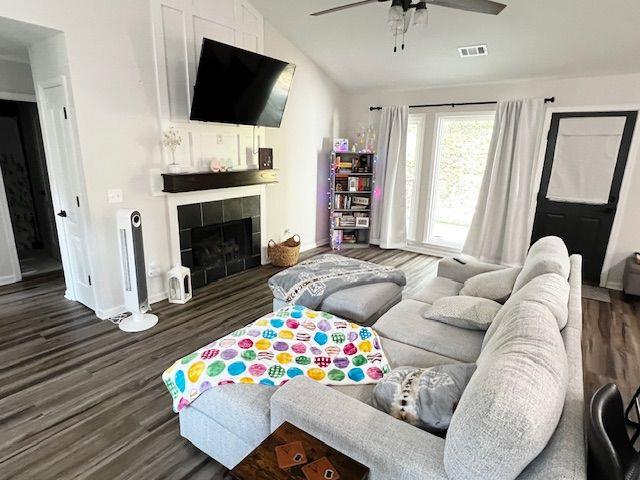 6060 Carriage Dr, Cumming, GA 30028 - living area with a tile fireplace, wood finished floors, ceiling fan, baseboards, and lofted ceiling