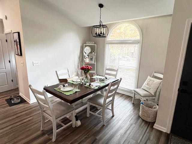 6060 Carriage Dr, Cumming, GA 30028 - dining area featuring dark wood-style flooring, a chandelier, and baseboards