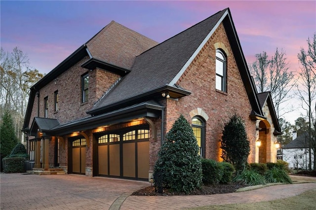 property exterior at dusk featuring a garage