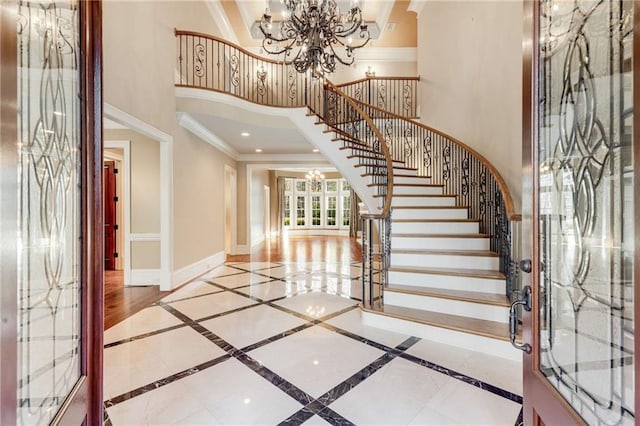 foyer with a chandelier and crown molding