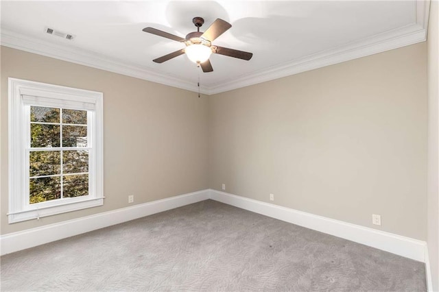 carpeted empty room featuring plenty of natural light, ceiling fan, and crown molding