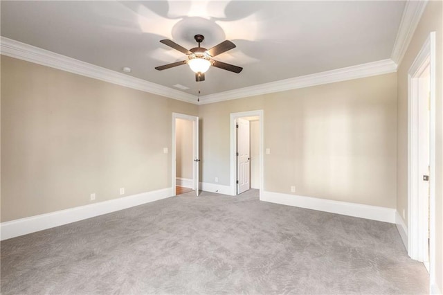 carpeted spare room featuring ceiling fan and crown molding