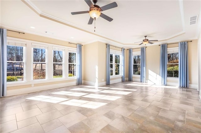 interior space featuring a tray ceiling, crown molding, and ceiling fan