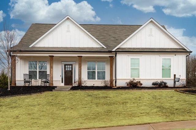 view of front of property with a front yard and covered porch