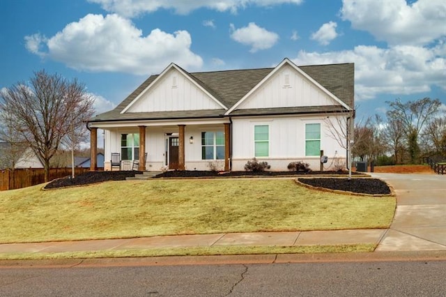 view of front of home with covered porch and a front lawn