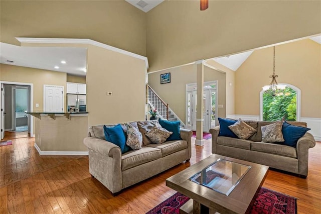 2709 Windrush Dr, Buford, GA 30518 - living area with wood-type flooring, a towering ceiling, stairway, and baseboards